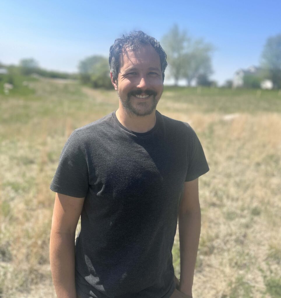 Alex Blondeau standing outside smiling