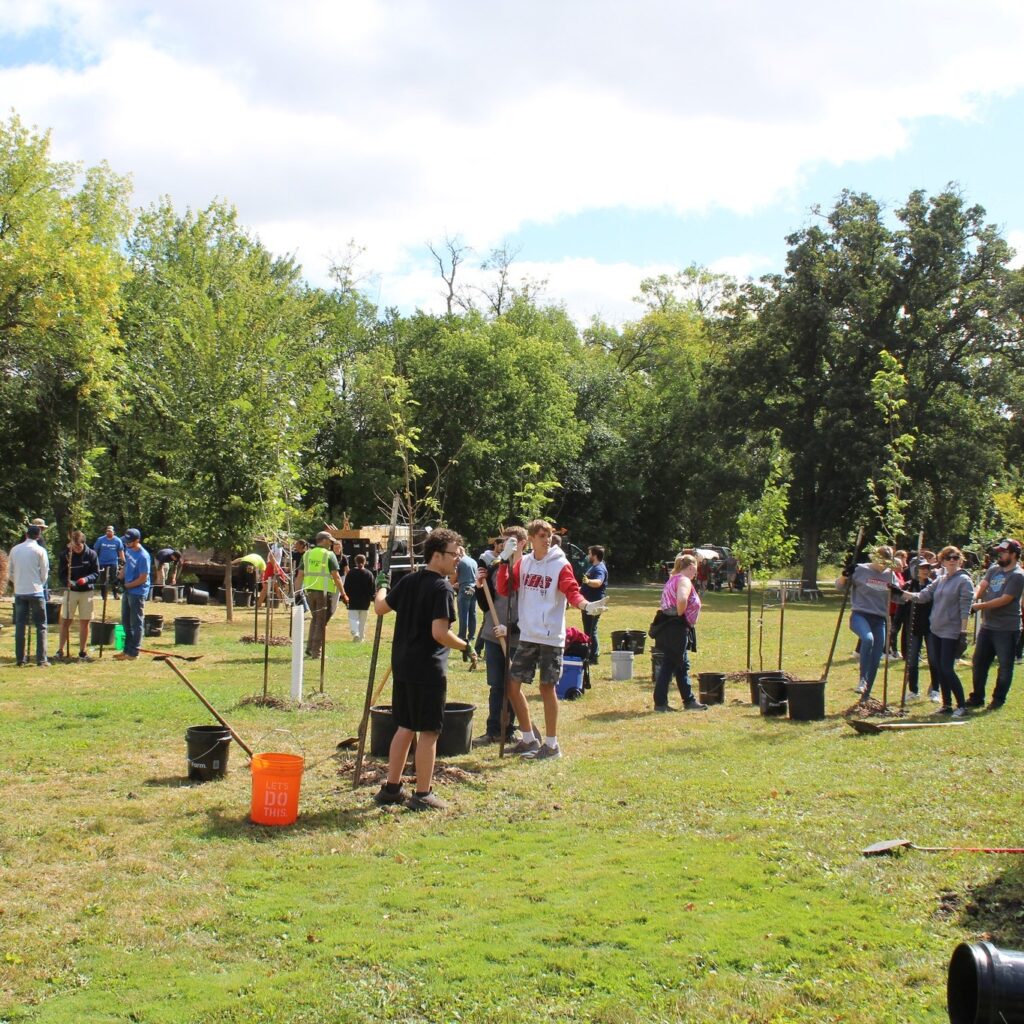 Volunteers planting trees near the Red River