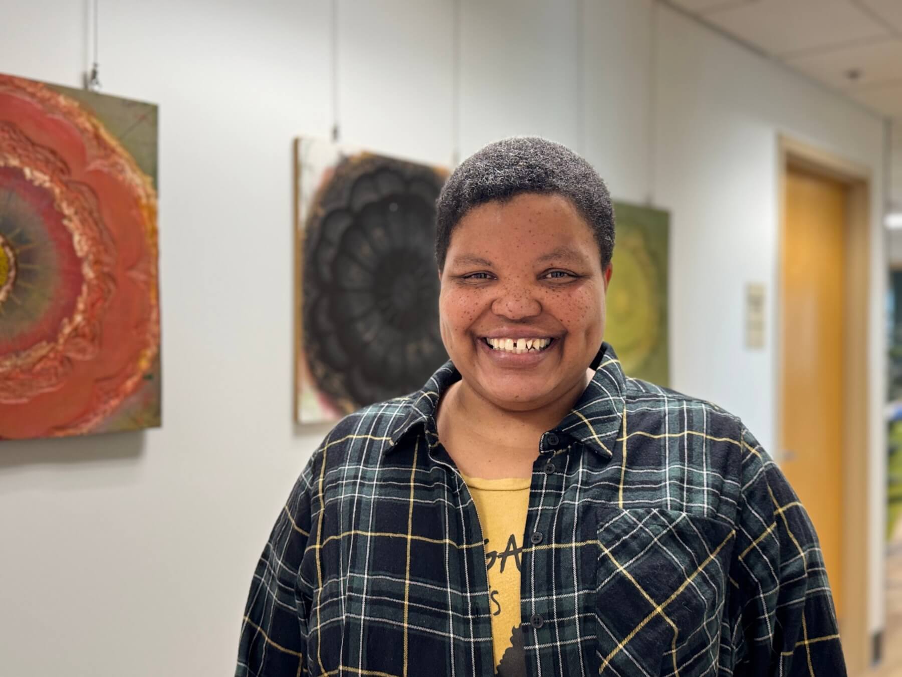 Victoria McWane-Creek stand in the hallway at West Central Initiative smiling.