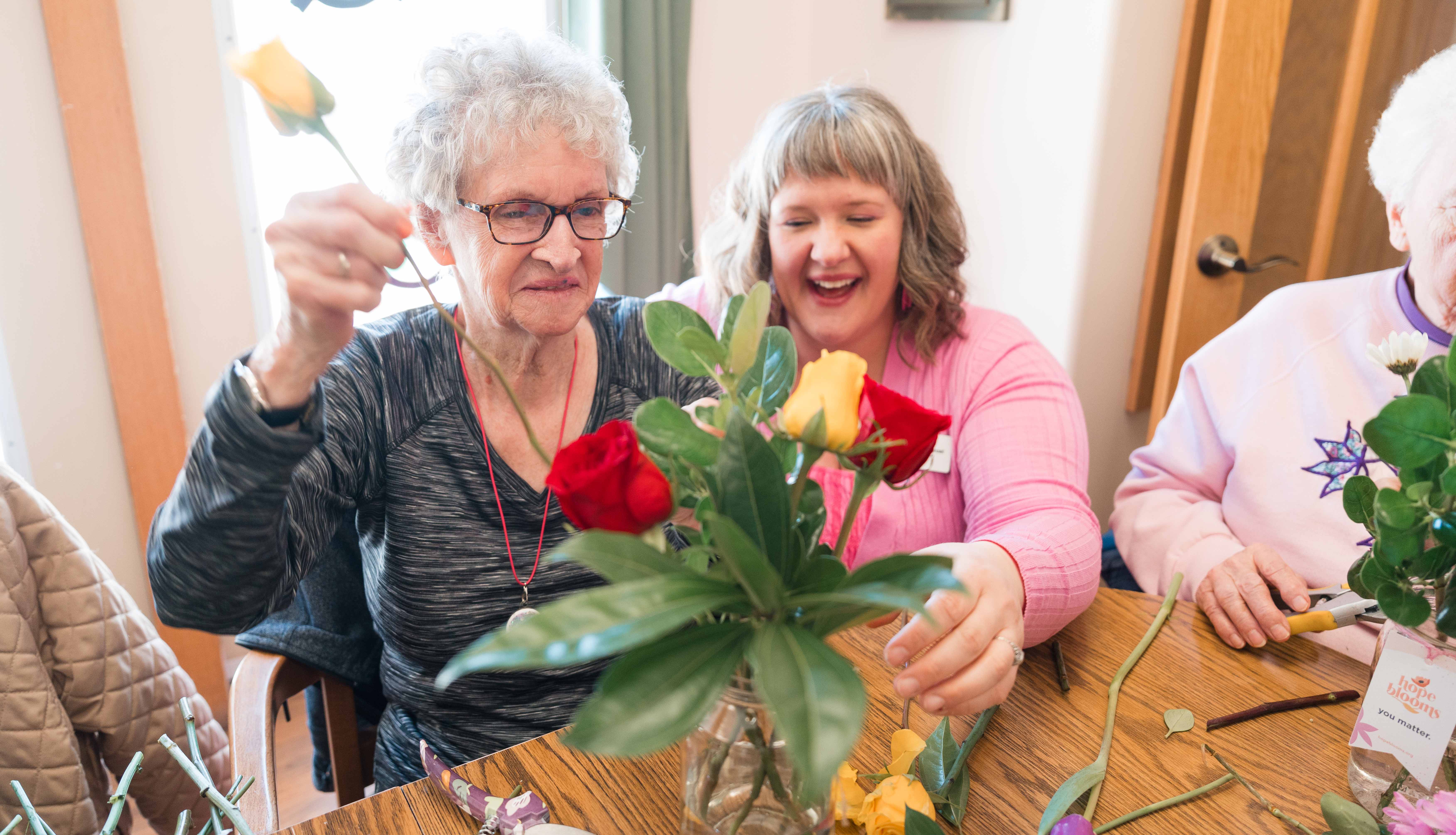Kelly from Hope blooms assist a resident in creating a bouquet.