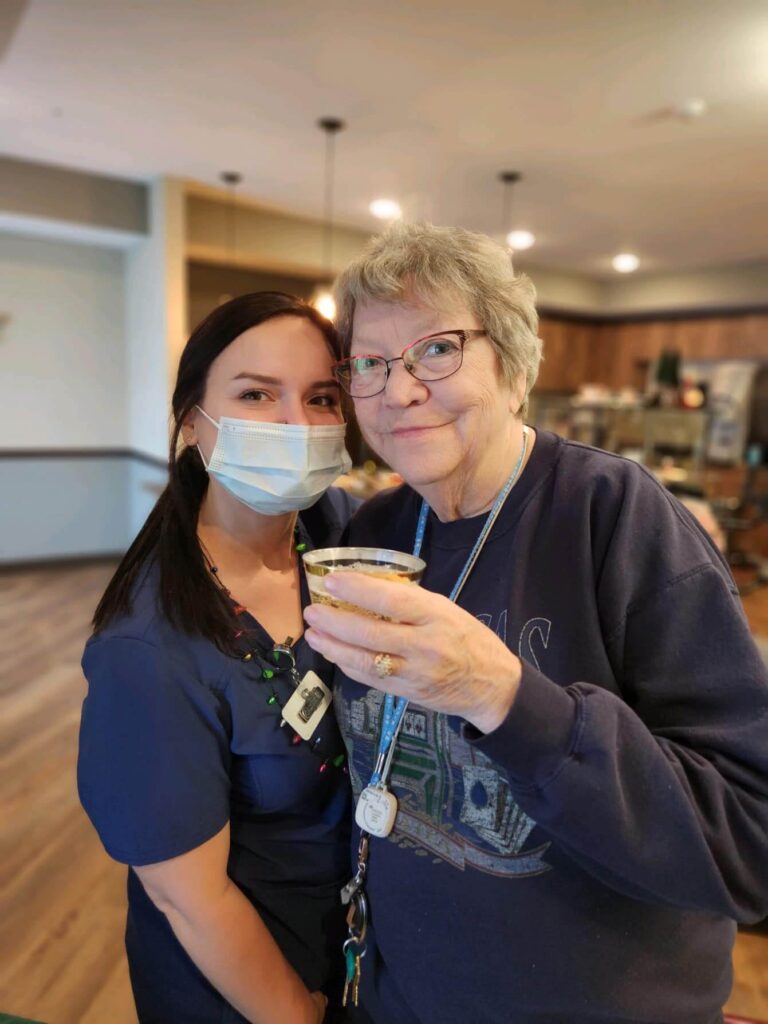 Two women posing, one older and one caretaker