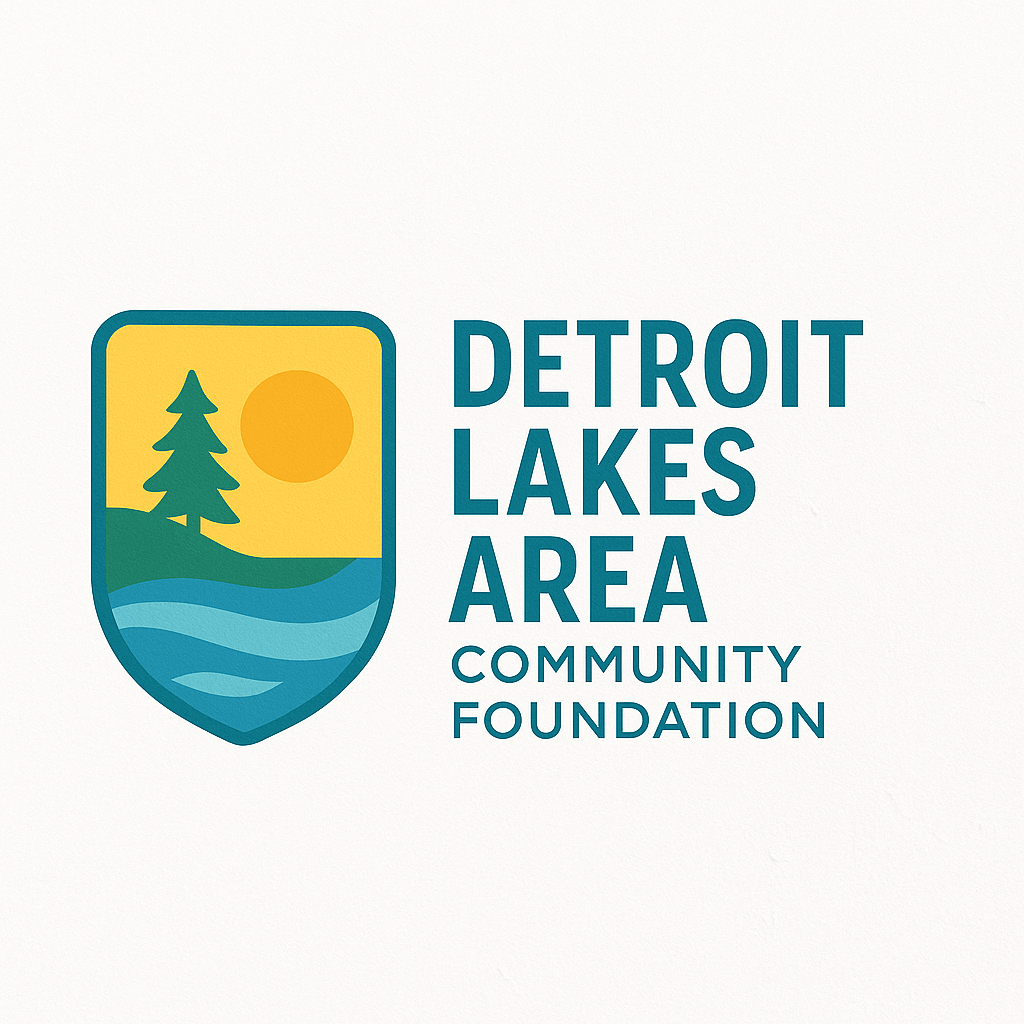 Logo for the Detroit Lakes Area Community Foundation featuring a shield-shaped emblem with a pine tree, sun, and blue lake waves, alongside teal text reading “Detroit Lakes Area Community Foundation.