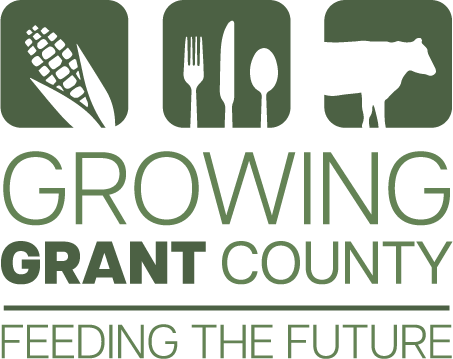Green logo reading “Growing Grant County – Feeding the Future,” with three square icons above the text showing an ear of corn, a fork and spoon, and a cow silhouette.