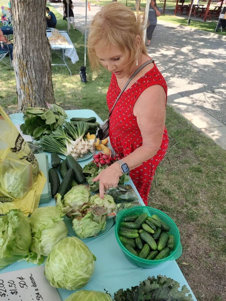 Woman looking at vegetables at farmers market