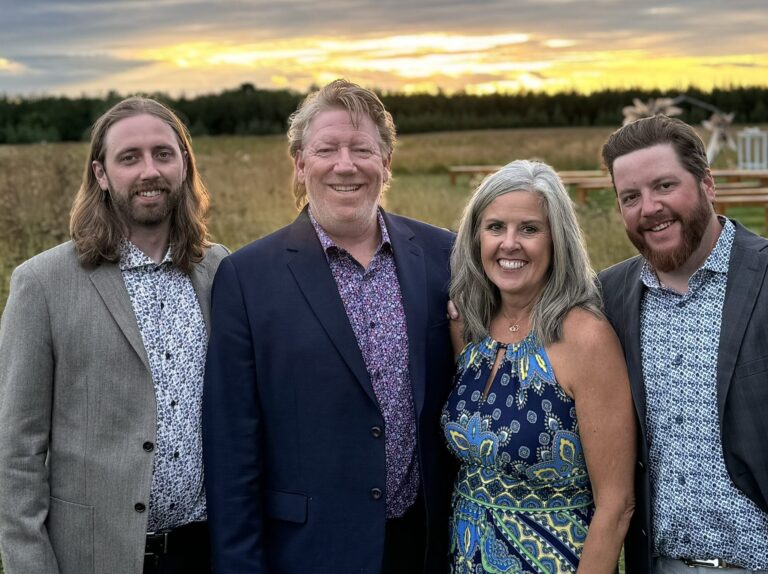 Dan and Barb Ostrander in the center with their adult sons at their sides.