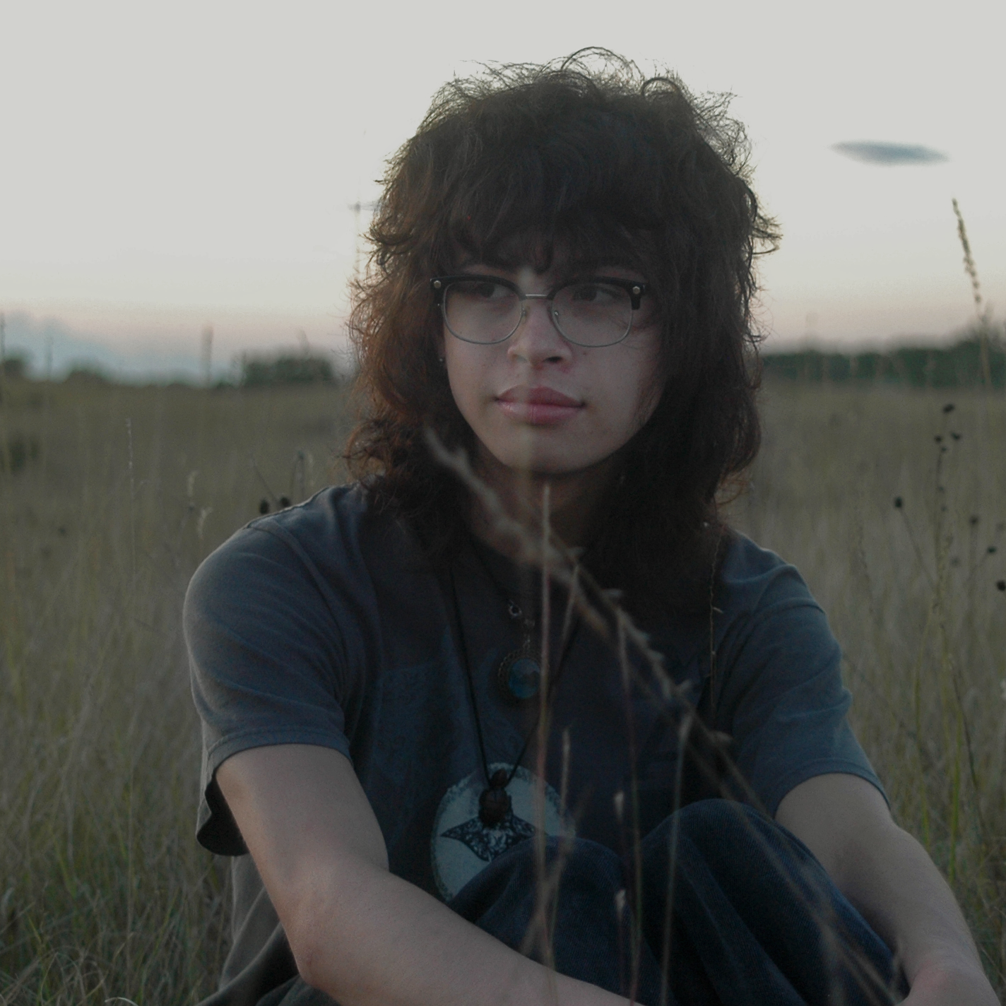 Roman Piper sitting in a field.